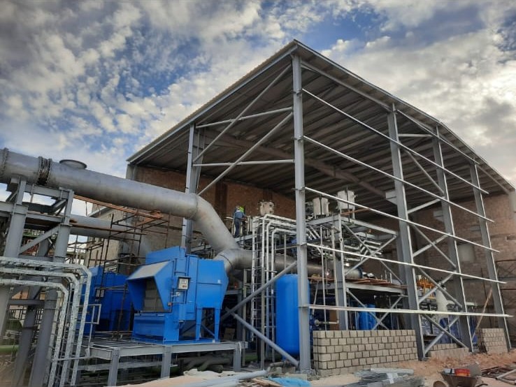 Steel-framed industrial plant with blue process equipment and ductwork